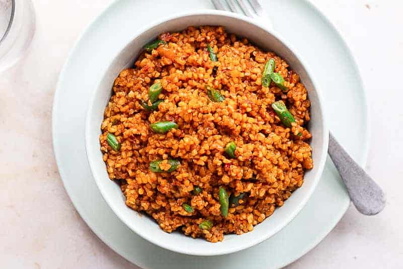 Jollof Bulgur. Bulgur wheat cooked in a spicy tomato and red pepper base sauce.