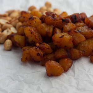 Kelewele | Spicy fried plantain on paper served with peanuts
