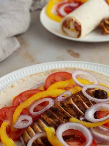 Tortilla wrap loaded with chicken suya and vegetables