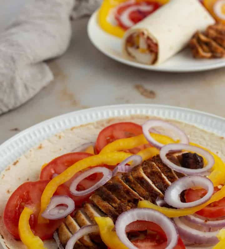Tortilla wrap loaded with chicken suya and vegetables