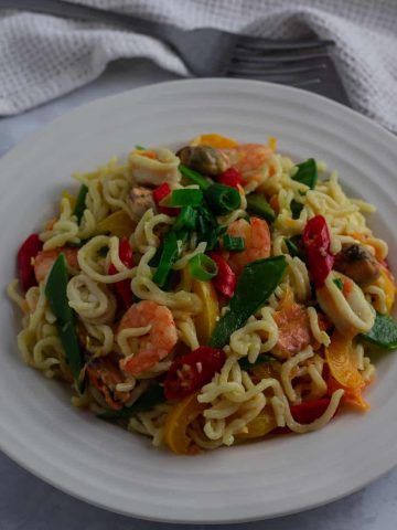 Nigerian Indomie noodles with vegetables and seafood in a bowl