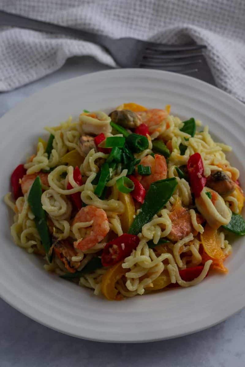 Nigerian Indomie noodles with vegetables and seafood in a bowl