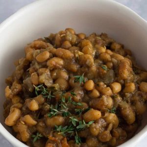 Caribbean black eyed beans in a bowl with a thyme garnish