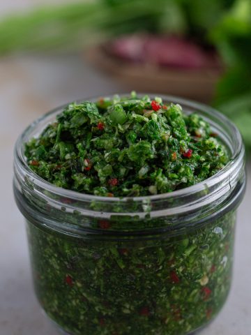 Caribbean green seasoning in a glass jar.