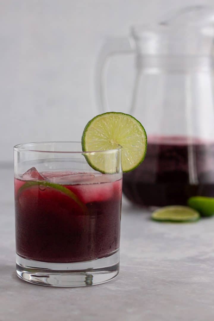 Sparkling zobo drink with lime garnish. Sparkling hibiscus drink