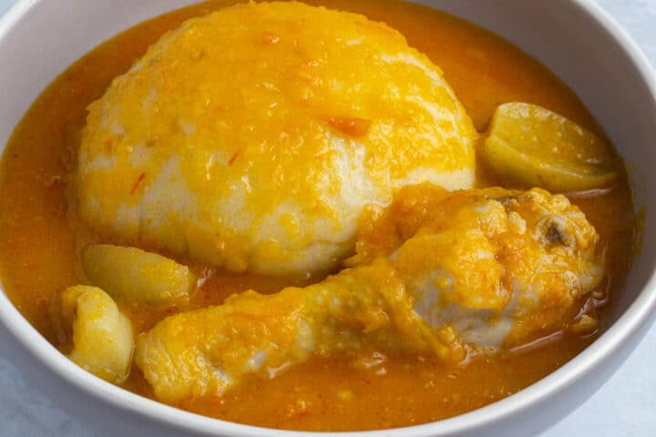 Ghana Light Soup with chicken in a bowl served with fufu