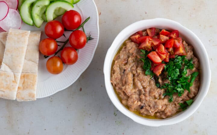 Egyptian Ful Medames with parsley and tomato toppings