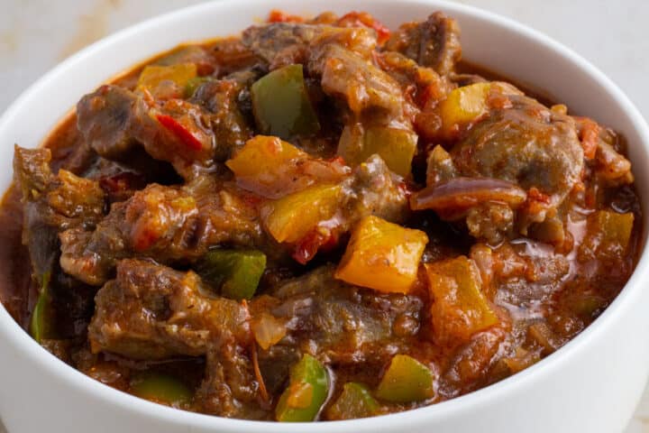 Nigerian spicy stewed gizzard served in a white bowl