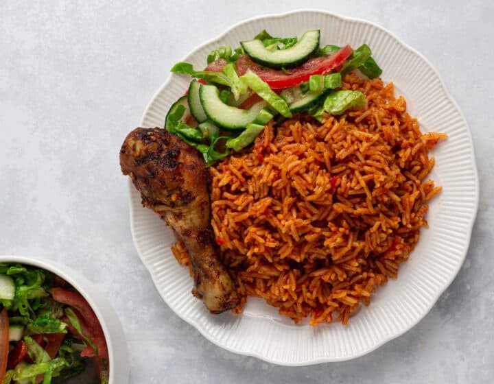Jollof rice served with salad and chicken