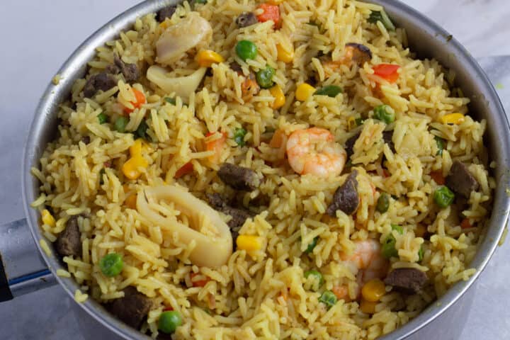 Nigerian fried rice with mixed seafood in a pot