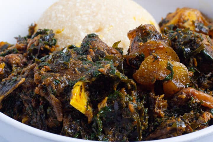 Afang soup, served with garri on a plate
