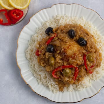 Chicken yassa served on a bed of white rice