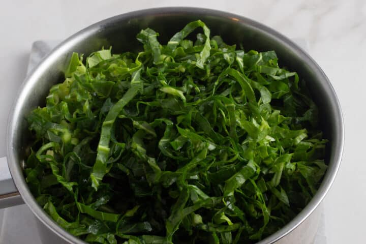 Sliced sukuma wiki (collard greens) in a pot