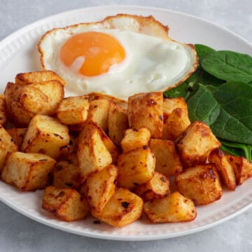 Air Fryer Breakfast Potatoes served with fried egg