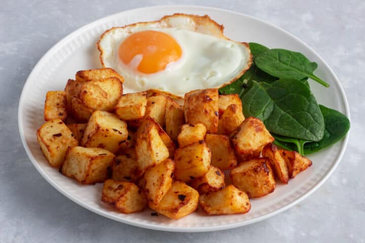 Air Fryer Breakfast Potatoes served with fried egg