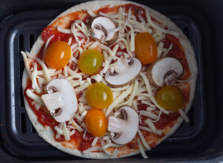 Air fryer tortilla pizza with mushroom and cherry tomato toppings