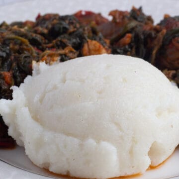 Sadza (Ugali) - served with spinach stew and meat on a plate